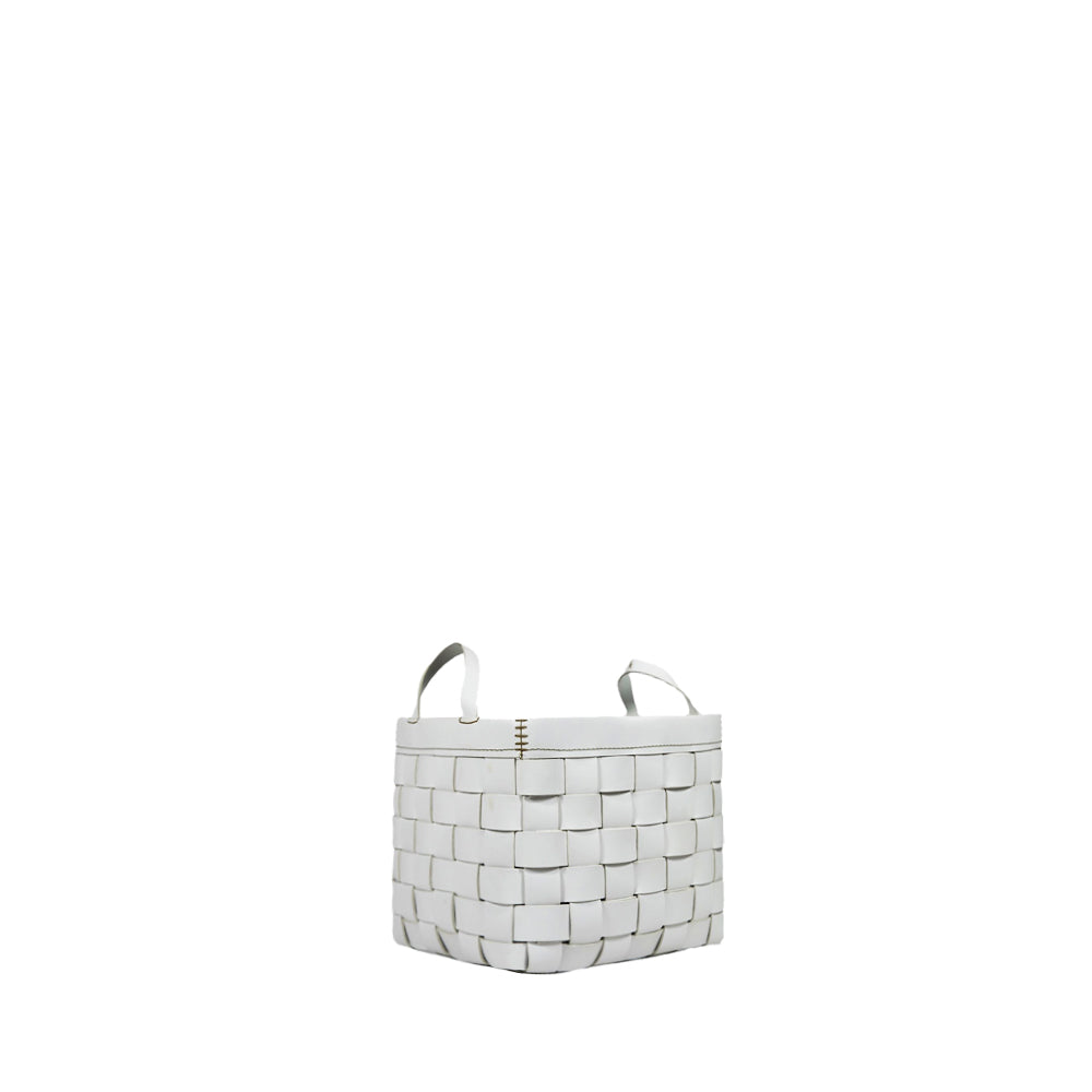 A white square leather basket with visible weave pattern